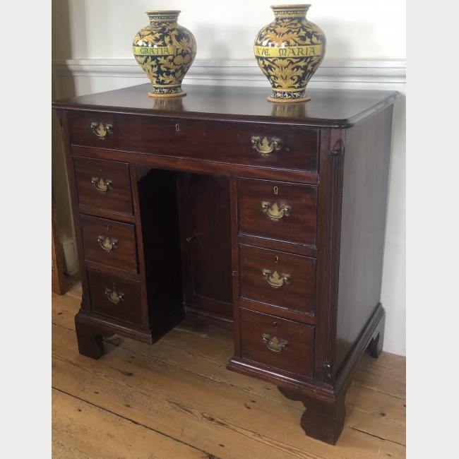 A GEORGIAN MAHOGANY KNEEHOLE DESK