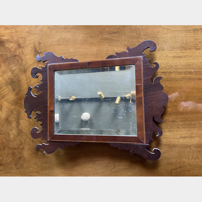 An early 19th Century mahogany and bevelled glass wall mirror.